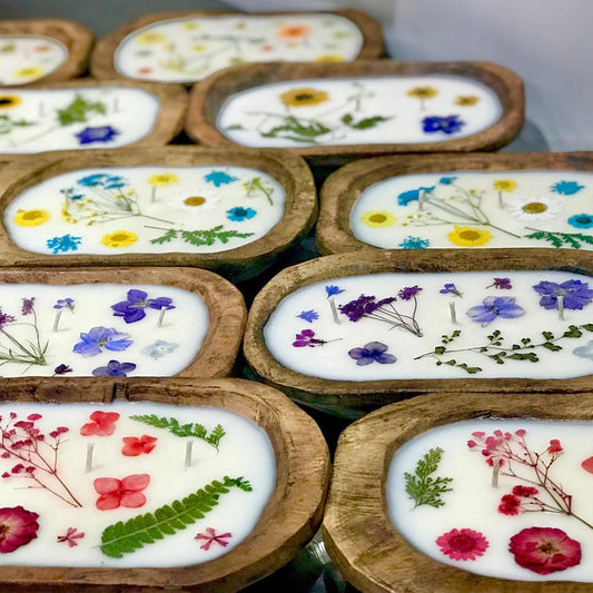 Soy candle with pressed flowers in natural reusable wood dough bowl