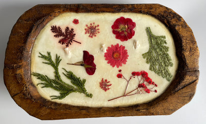 Soy candle with pressed flowers in natural reusable wood dough bowl