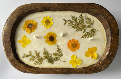 Soy candle with pressed flowers in natural reusable wood dough bowl